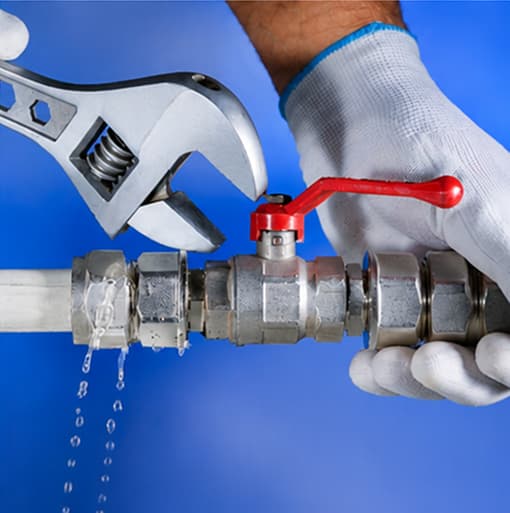 Conejo Bros plumber tightening a pipe fitting